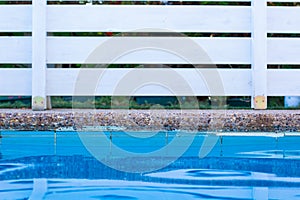 Soft focus concept swimming pool side water surface and garden white wooden deck wall background object outside space for copy or