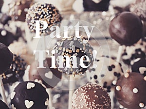 Soft focus of delicious cake pops with PARTY TIME overlay text