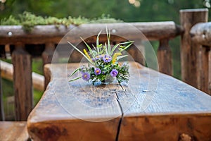 Soft focus of a floral centerpiece on a wooden table at Hija glamping Lake Bloke in Slovenia photo