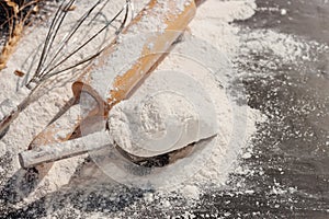 Soft focus: flour, ears of wheat barley cooking bread, and cookies arranged on a wooden tabletop in a rustic kitchen, top view