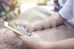 Soft focus of hand of Asian man use smart phone and holding credit card for paying online