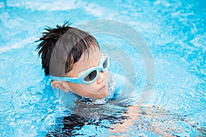 Soft focus on Happy young asian kid with swim goggles