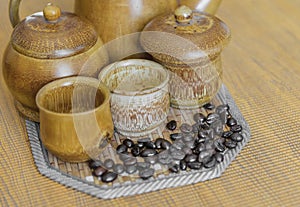 Soft focus image of coffee beans and coffee cups set on wooden b