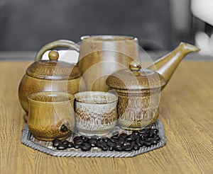 Soft focus image of coffee beans and coffee cups set on wooden b