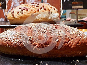 Soft focus of multigrain bread on black plate in restaurant