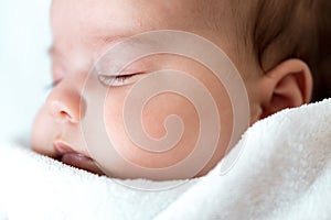 soft focus Newborn baby extreme close-up. Side view of a chubby plump infant baby 4-8 months sleeping soundly on his