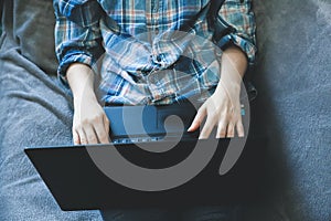 Soft focus photo. Woman with laptop is working from home. Online freelance during the time of quarantine. Coronavirus pandemia.