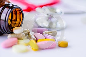 Soft focus pills with stethoscope and pill bottle background