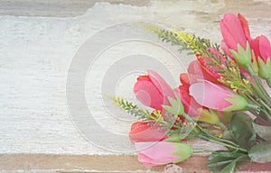 Soft focus of pink flowers bouquet on wood