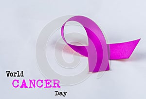 Soft focus Purple CANCER awareness ribbon on white background.