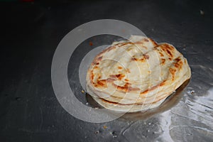 Soft focus of Roti Canai or Roti thresh flour by roti maker with oil