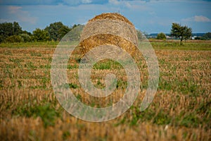 Soft focus of stack of hay agriculture field rural scenic view in end of summer season