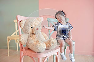 Soft Focus of a Two Years Old Child Sitting with her Teddy Bear.