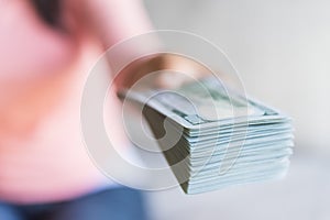 Soft focus on woman hands proposing money us dollar bills