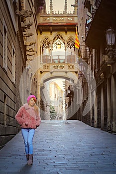 woman standing in front of Pont del Bisbe in Barcelona photo