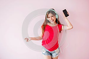 Soft focus of Young Woman Enjoying with Music From Smart Phone a