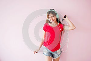 Soft focus of Young Woman Enjoying with Music From Smart Phone a photo