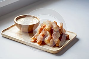 Soft focus of Youtiao or Cakwe with milktea custard on brown wooden background. Thailand street food  is call `Patongo`.
