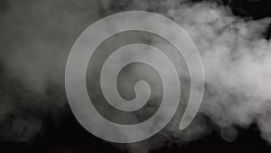 Soft Fog in Slow Motion on Dark Backdrop. Realistic Atmospheric Gray Smoke on Black Background. White Fume Slowly