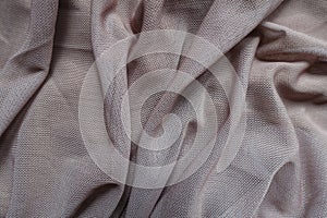 Soft folds on dull dusky pink unprinted polyester mesh