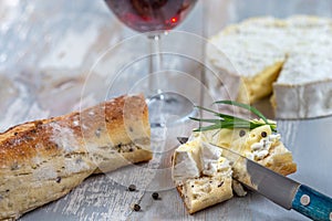 Soft French cheese Coulommiers, bred and a glass of red wine.