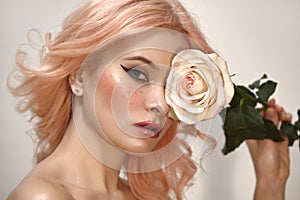 Soft-Girl Style with Trend Pink Flying Hair, Fashion Make-up. Blond Woman Face with Freckles, Blush Rouge, Rose Flower