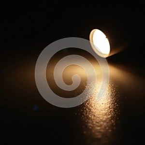 Soft glow illuminates a single light bulb on a dark surface, lightbulb, glowing, lightsource