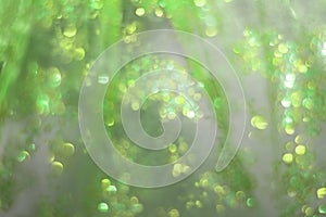 Soft glowing golden green festive background. Colored abstract blurry backgrounds. New Year