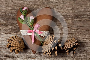 Soft heart made of cloth with pink roses on a wooden background