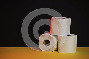 Soft hygienic toilet paper on a black yellow background