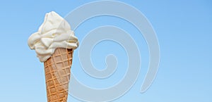 Soft ice cream cone on blue sky