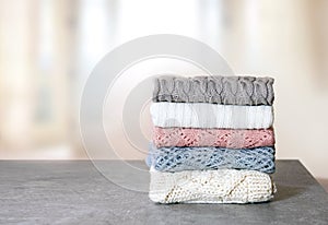 Soft knitted clothes stack,woolen apparel folded on table. Winter garment.Stacked clothing