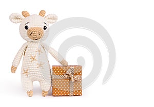 Soft knitted toy bull. Soft toy gift copy space