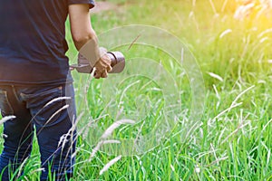 Soft Light and Blurred image, A photographer capturing the beautiful Grass flowers in the evening with a DSLR camera,