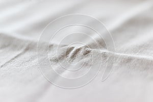 Soft light gray natural linen texture with focus on the fold. Crumpled fabric background