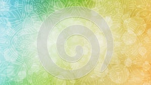 Soft lime green, yellow and orange textured bokeh background with mandala
