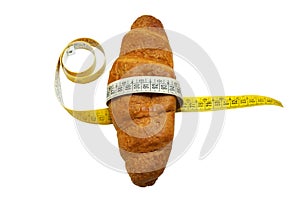 Soft measuring ruler wrapped around a croissant as a symbol of unhealthy nutrition, isolate on a white background