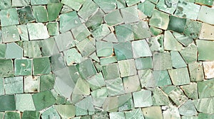 Soft mint green tiles are meticulously p to create a serene mosaic that evokes the feeling of walking through a peaceful photo