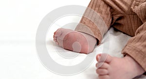 Soft newborn baby feet on a white blanket, closeup. Maternity, family, birth concept.