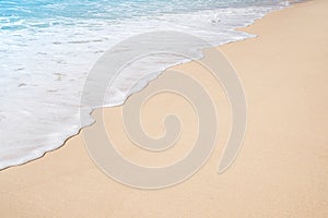 Soft ocean wave on tropical sandy beach in summer background with copy space