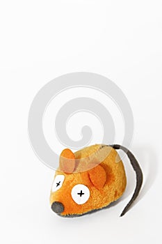 Soft orange mouse toy made of artificial wool, handmade on a white background