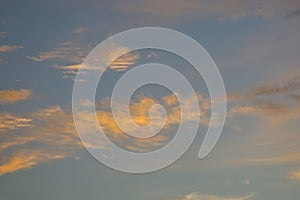 Soft pastel clouds in a calm evening sky with warm light