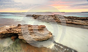 Soft pastel colours of a sunrise at Hyams Beach Australia