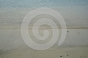 Soft pastel sandy beach with fresh crystal clear sea water wave line background and copyspace on Ornos shore