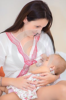 Soft photo young mother feeding breast her baby