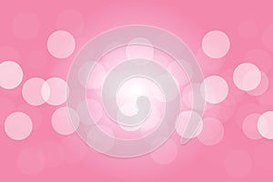 Soft pink bokeh background with radial sunlight at center