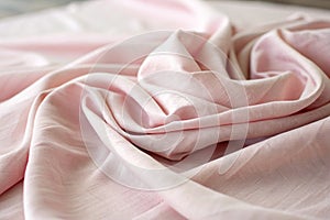 Soft pink fabric folds with light textures photo