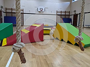 Soft play equipment spread out across the gym floor