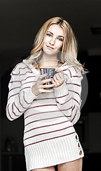 Soft portrait of teenage girl drinking hot coffee at home