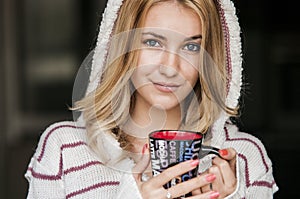 Soft portrait of teenage girl drinking hot coffee at home